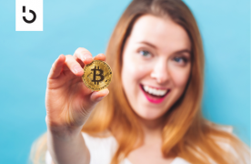 holding a gold coin with bitcoin symbol