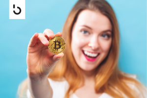 holding a gold coin with bitcoin symbol