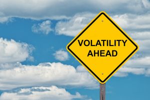Yellow diamond shaped sign labeled volatility ahead.