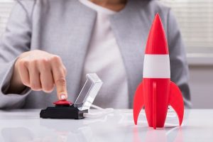 Person launching a miniature rocket.