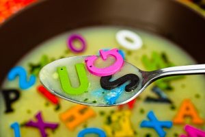 Bowl of soup with plastic multi colored letters.