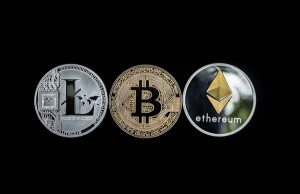Gold and silver coins labeled Litecoin, Bitcoin and Ethereum.