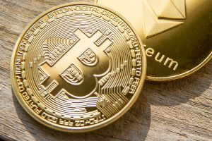 Gold coins with bitcoin and ethereum symbols.