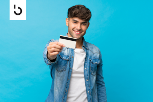 Smiling man holding a debit card