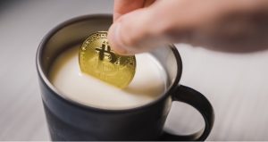 coffee and gold coin with bitcoin symbol