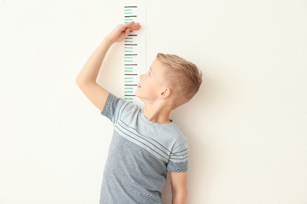 boy measuring his height
