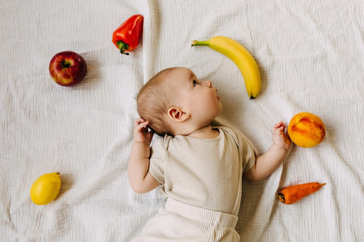 baby with healthy fruit