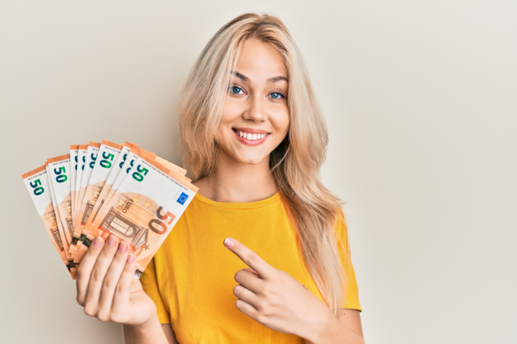 woman holding a fan of paper money