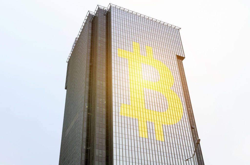 skyscraper with bitcoin logo on display