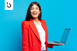 smiling woman holding a laptop