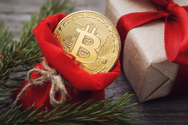 gold coin with bitcoin symbol in a red gift bag